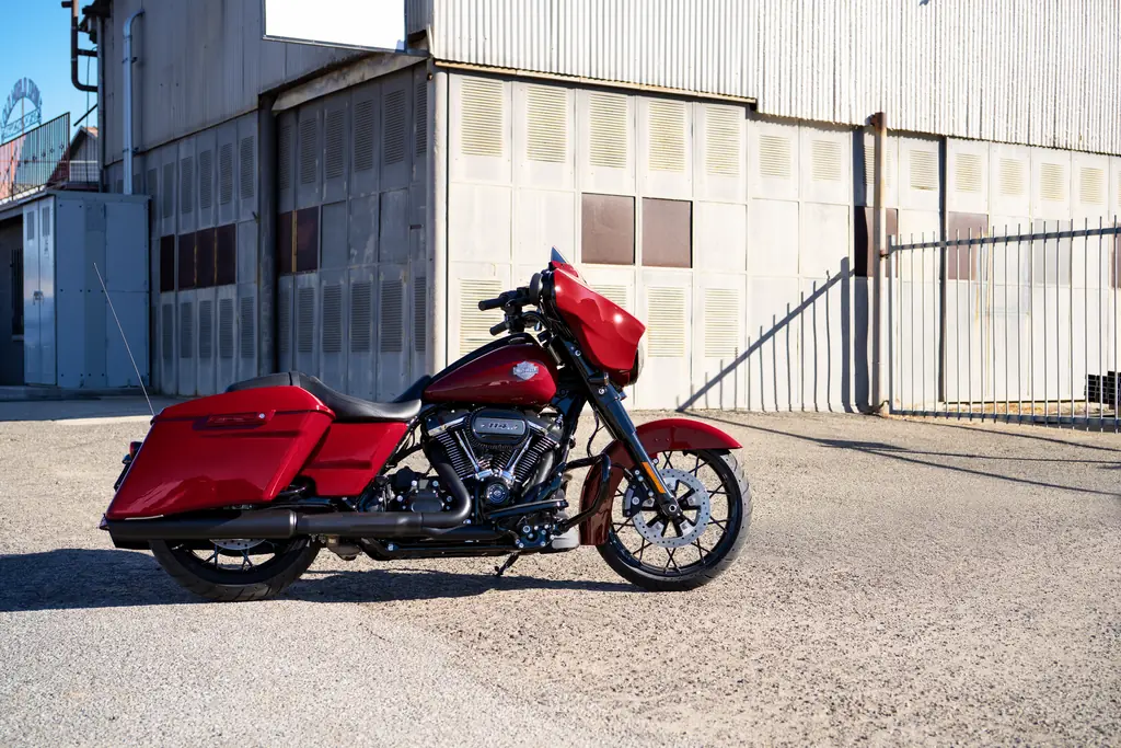 2021 Harley-Davidson Street Glide Special, red, blacked-out finish, parked by an industrial building